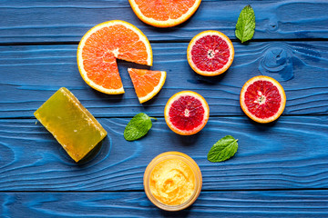 organic cosmetic with citrus on blue background top view