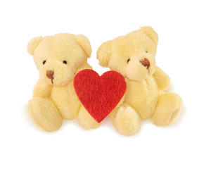 Two teddy bears with red heart on white.