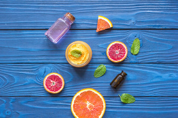 organic cosmetic with citrus on blue background top view