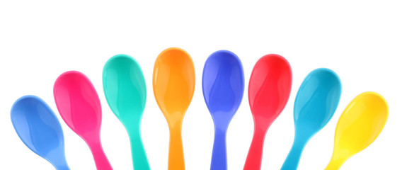 Eight colorful plastic spoons
