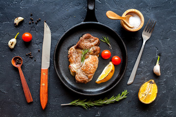 Fototapeta na wymiar concept cooked steak on dark background top view