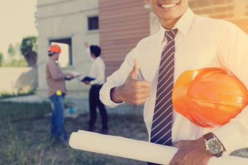 architect and engineer inspect housing estate building to success construction plan before send...
