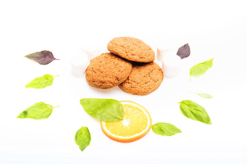 oatmeal cookies, mint leaves and orange dessert isolated on white
