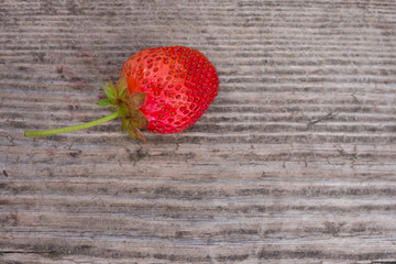Strawberry on wooden background closeup.
