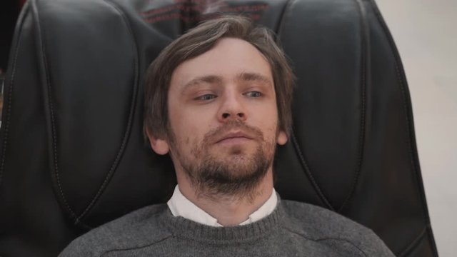 Man in shopping mall lay in massage chair close up shot