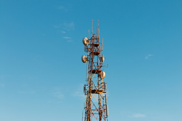 Telecommunication mast TV antennas with blue sky in the morning