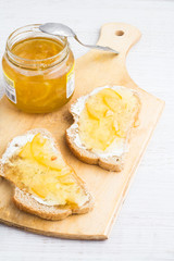 toast with orange marmalade on a white background