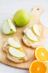 Fototapeta na wymiar toast with jam and apple, oranges closeup on white background
