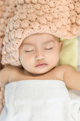 Baby sleeping on bed in the bedroom