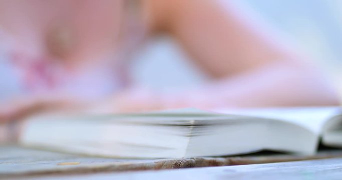 Young Woman Reading Book - Close up of Hand Turning Pages 2
