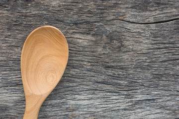 empty wooden spoon on old natural wood background
