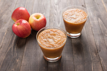 Flash red apples smoothie on Wooden background