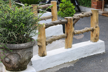 small decorative bridge with wooden handrail from a tree