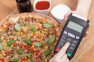 Using payment terminal for paying in restaurant, enter personal identification number, vegetarian...