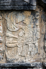 Ancient Mayan mural depicting a warrior on the Platform of the Skulls, a.k.a. Tzompantli in Chichen Itza, Yucatan, Mexico