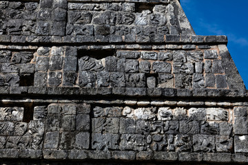 Ancient Mayan carving on the facade of the Osario pyramid in the Chichen Itza archaeological area in Yucatan, Mexico.