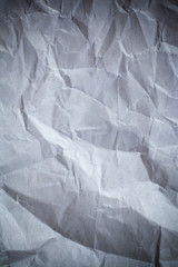 Recycled crumpled gray paper background dark edged.