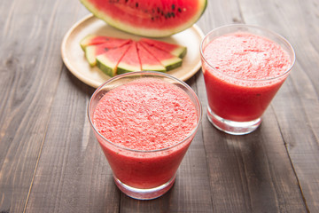 Healthy watermelon smoothie on a wood background
