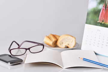 Glasses, pencil smartphone and notebook for planning