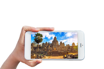 Hand holding Smartphone with image of Angkor Wat Temple, Siem reap in Cambodia.