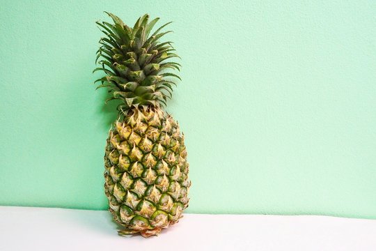 Isolated Tropical Pineapple on Mint Green Background