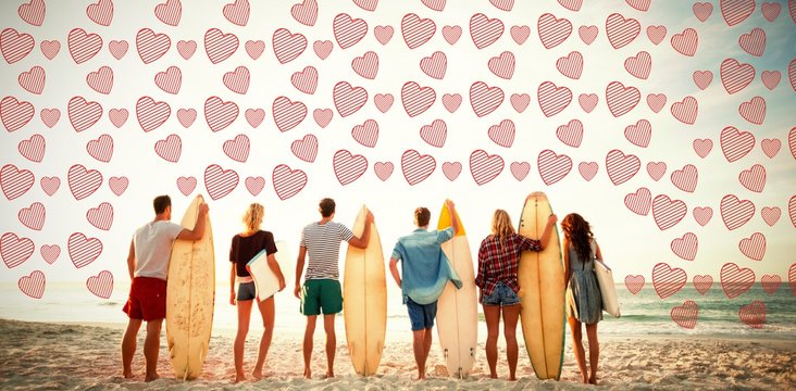 friends holding surfboard at beach