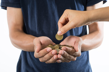 woman hand collecting coins in her hands and another hand giving