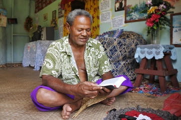 Indigenous Fijian man reads the bible in Fiji - obrazy, fototapety, plakaty