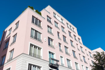 Fototapeta na wymiar Modern pink apartment house seen in Berlin, Germany