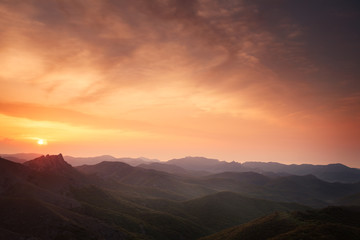 Dawn over the mountains with clouds.