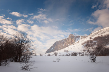 Rock Eklizi Burun in the snow under a blue sky with clouds