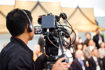professional cameraman - covering on event with a video 