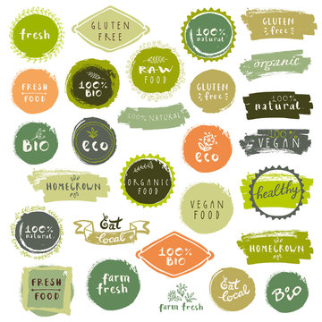 Organic food labels set. Fresh healthy food icons. Vintage badges for restaurant menu or food package. Eco friendly raw vegan products logo templates. Hand lettering, calligraphy, brush smears