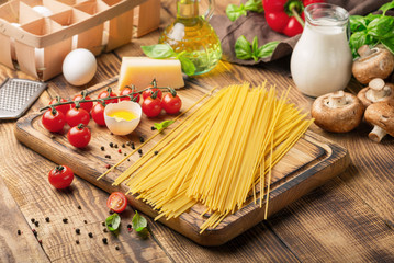 Raw Italian spaghetti with different ingredients for cooking Ita