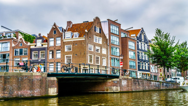 Historic houses with Bell Gables, Spout and Neck Gables dating back to the Middle Ages along the canals of Amsterdam