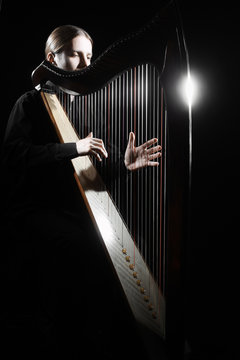 Harp player Irish harpist playing musical instrument