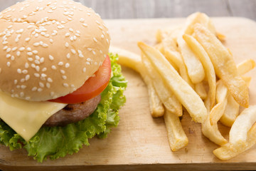 BBQ hamburgers with french fries on wooden background