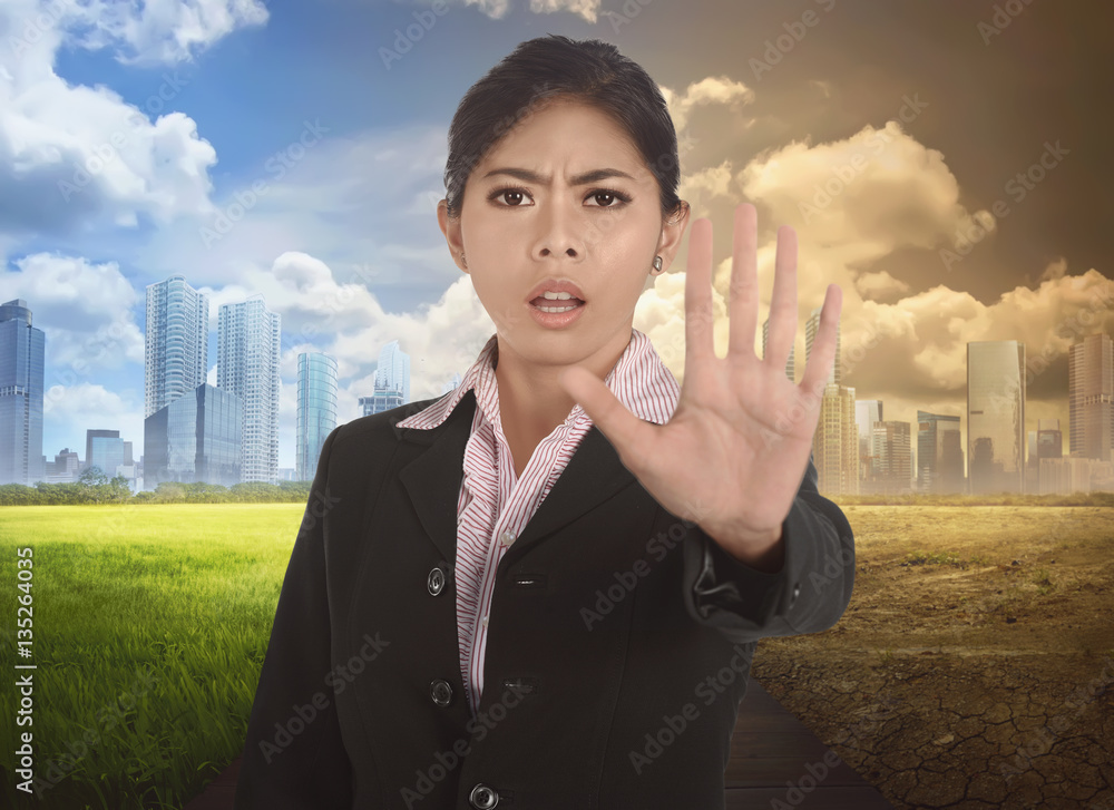 Wall mural Young asian business woman with gesture to stop changing environment