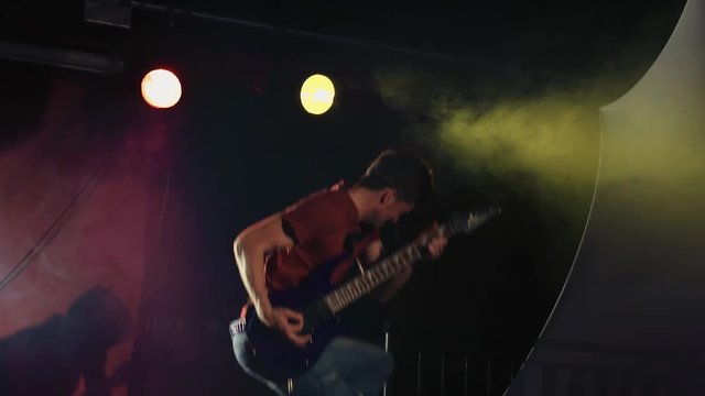 Rock n' Roll Electric Guitarist Jumping in Slow Motion 3