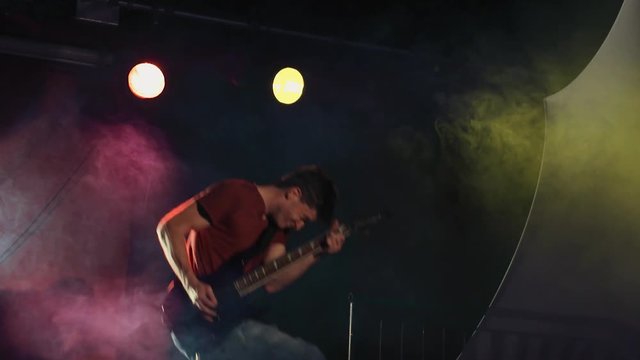 Rock n' Roll Electric Guitarist Jumping in Slow Motion