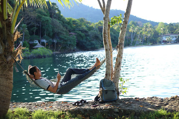 Man sleeping in a hammock at the beach