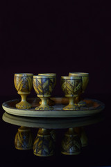 Wooden shot glass on plate.