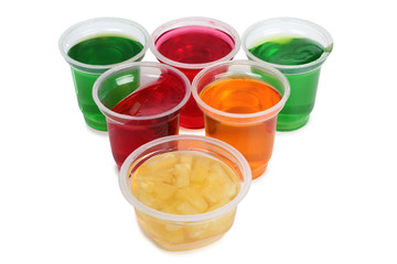 Jam in plastic with raw fruit on white background