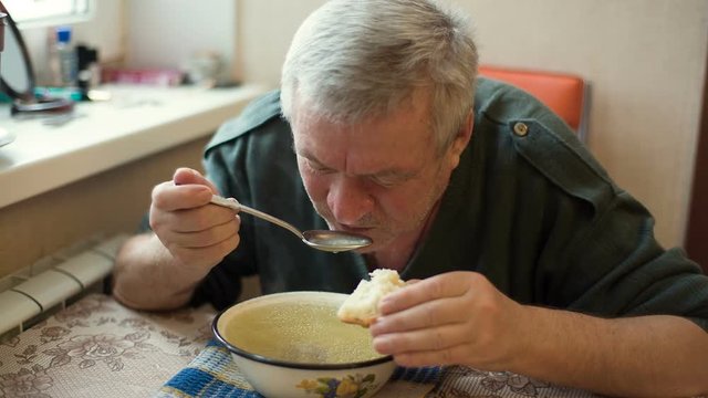 Rural Man eating soup