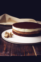 delicious three-layer chocolate cake stands on a circular base