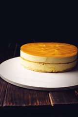 delicious multi-layered fruit mango cake stands on circular base