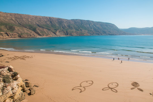 Figures in sand on the beach of Imsouane Morocco