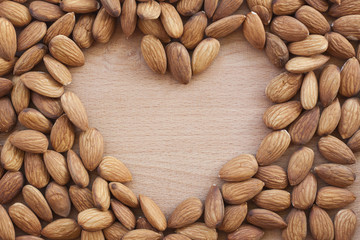 Almonds isolated on a white background, or on a plain wooden table.