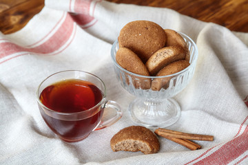 Cup of hot tea and oatmeal cookies with cinnamon