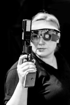 Woman with pistol on sport shooting training